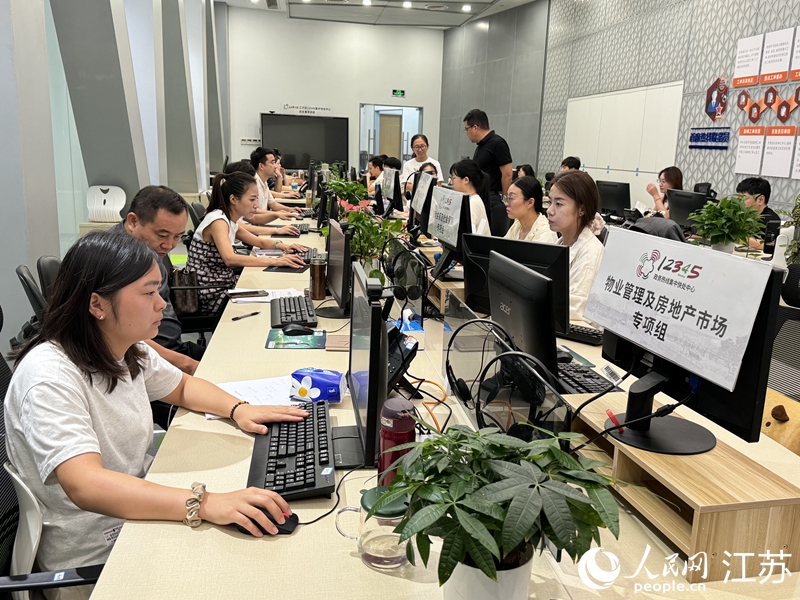 江宁区快处中心，各单位派驻工作人员相邻而坐，集中会办群众诉求。人民网 杨维琼摄